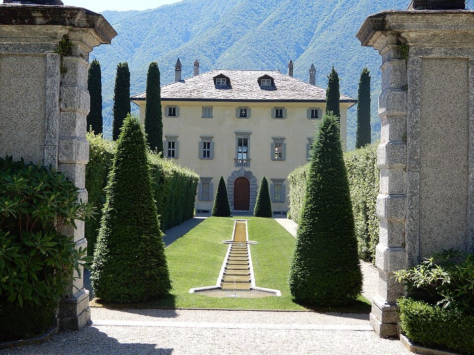Private Cranchi boat cruising past Villa del Balbianello on Lake Como with guests enjoying aperitivo aboard